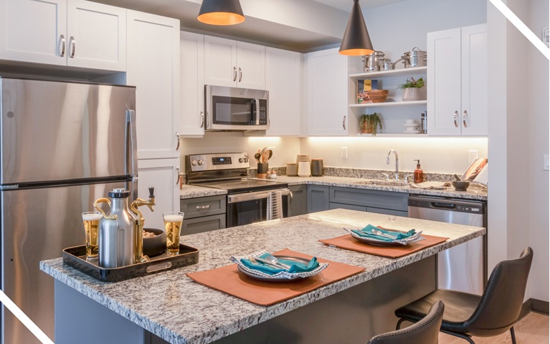 kitchen with stainless steel appliances and island - The Beam apartments New London Conn